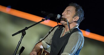 Bruce Springsteen plays harmonica and guitar during his set for The Concert for Valor in Washington, D.C. Nov. 11, 2014. DoD News photo by EJ Hersom
